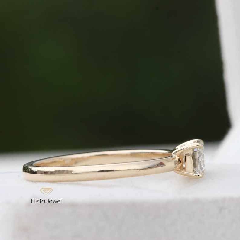 East West Emerald Cut Solitaire Ring