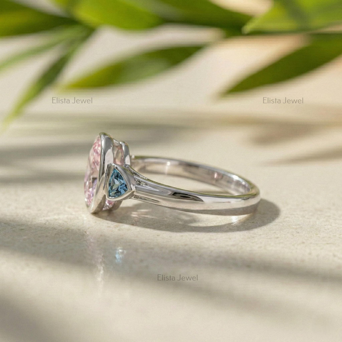 Oval Pink Lab Grown Diamond Three Stone Bezel Set Engagement Ring With Accent Trillions