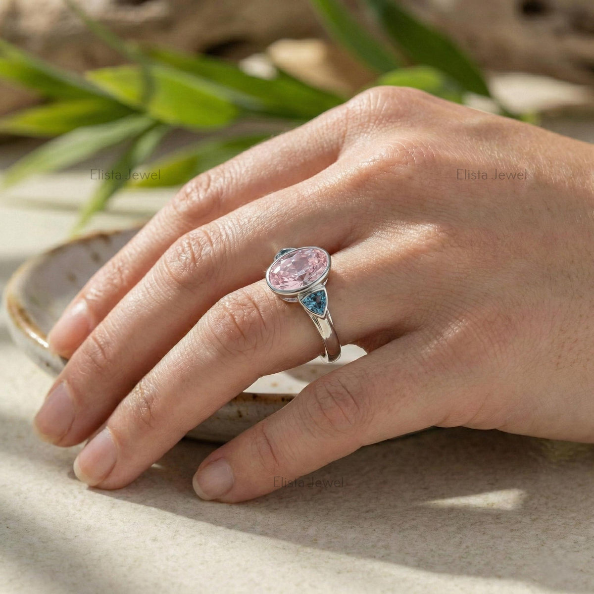Oval Pink Lab Grown Diamond Three Stone Bezel Set Engagement Ring With Accent Trillions